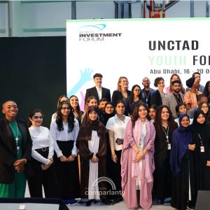 Costado izquierdo de una fotografía en el escenario del Unctad donde se encuentran todos los y las jóvenes que participaron del foro. ‌